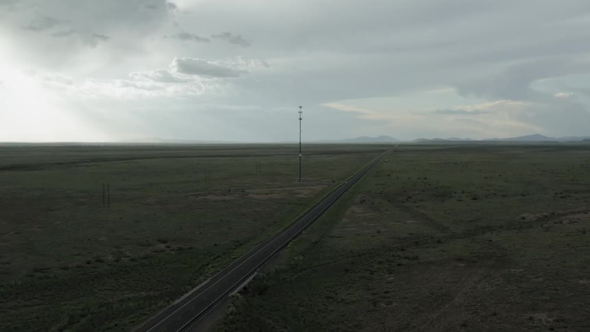 A single car travels on the highway below