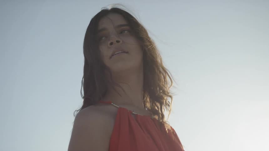 A woman wearing a dress is outside