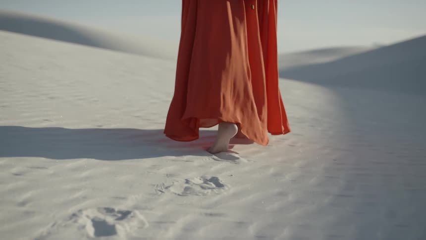 A woman walking in a desert