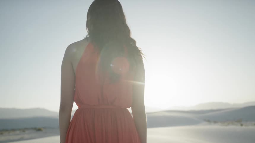 A woman walking in a desert