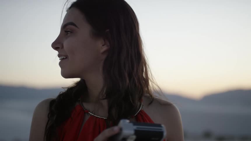 A woman looks away from her camera