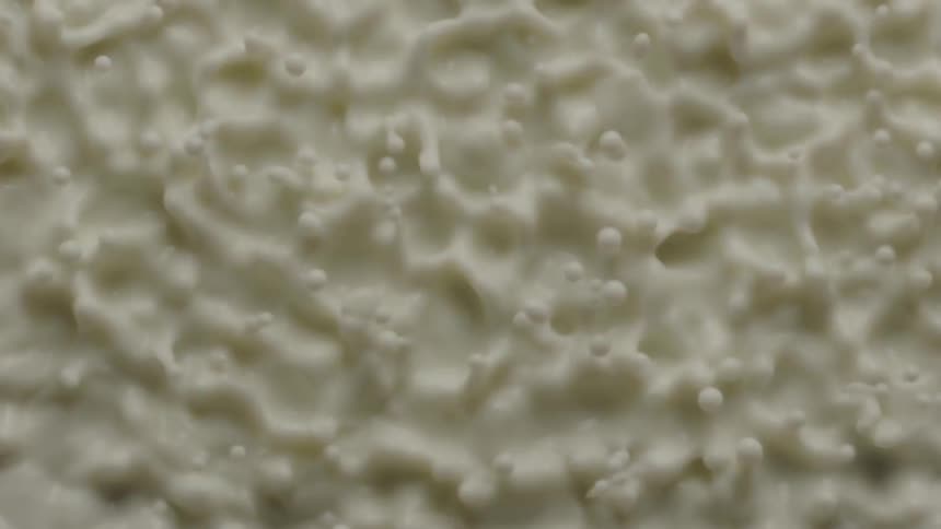 A white fluid bounces and forms patterns