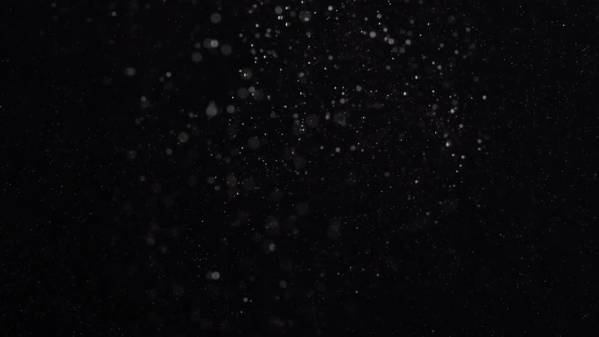White particles float through through the air