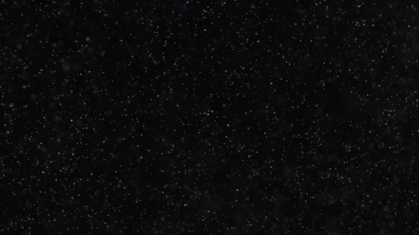 Dots of white moving in patterns on a black background