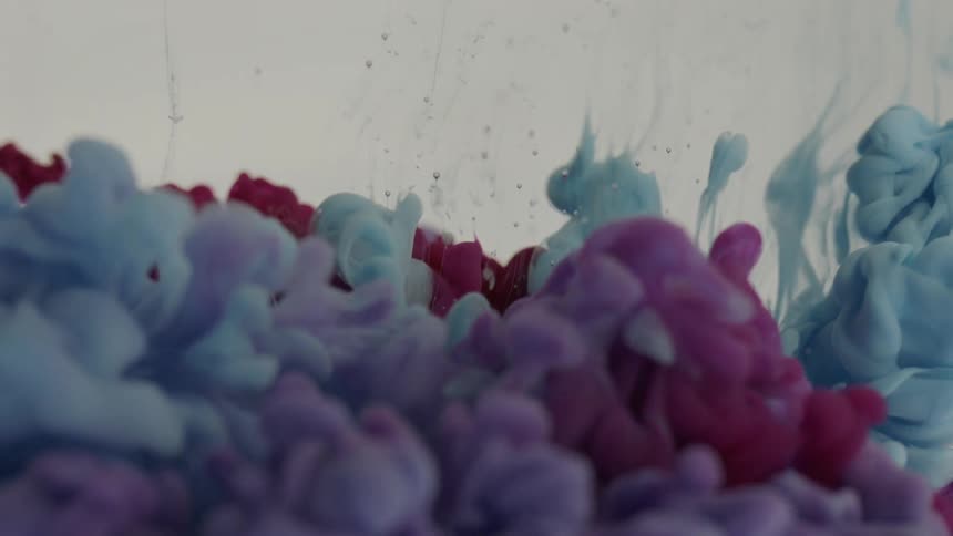 Blue and maroon liquids mix together to form different colors