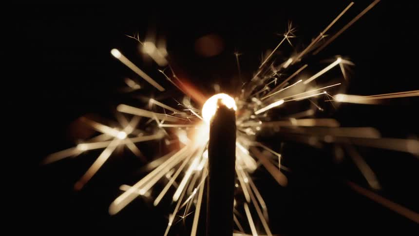 A match lights a sparkler firework