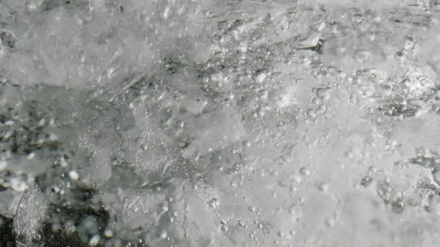 Liquid pours into the icy drink