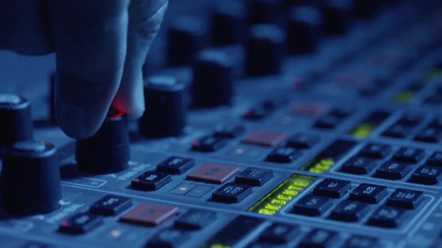 A persons fingers turning a knob on a mixer