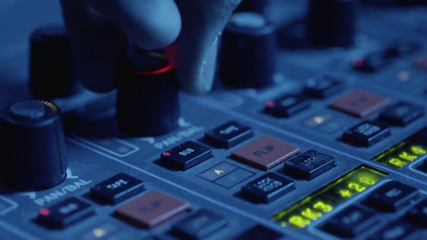 Mans hand operates the button of the device in the dim light room