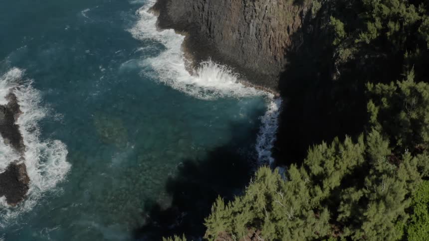 Birds eye view of waves crashing in to a cliff