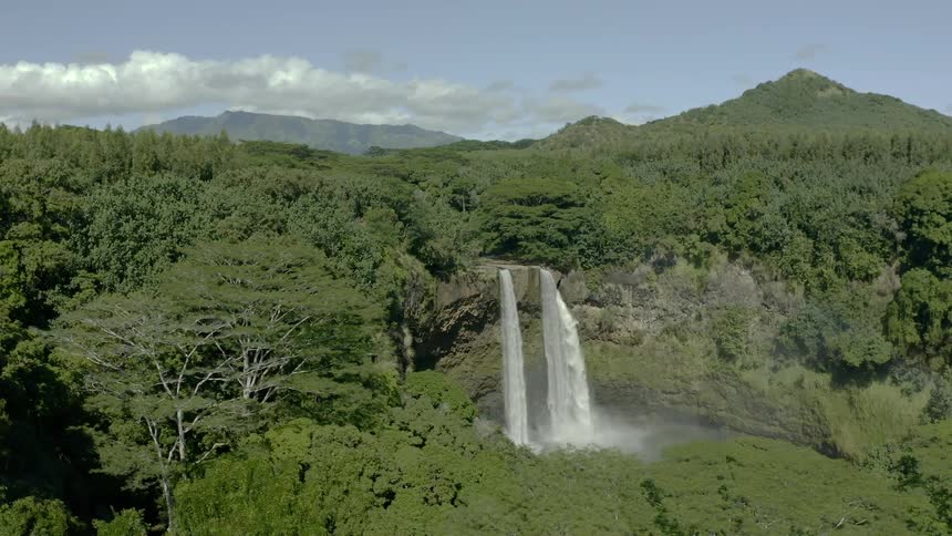 A waterfall crashes over the rocks and in to the water below