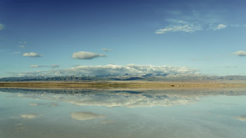 The sky and clouds are reflecting on the ocean water