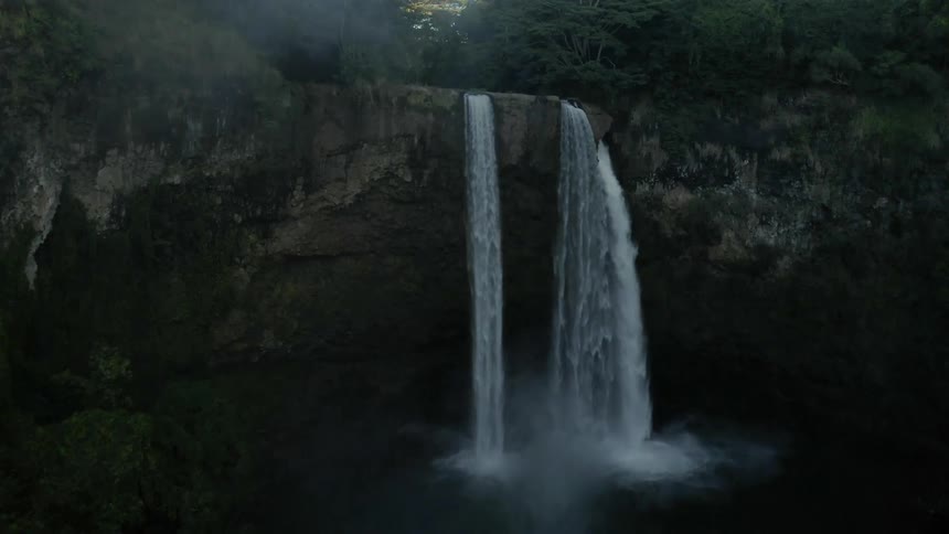 A waterfall cascades over a cliff