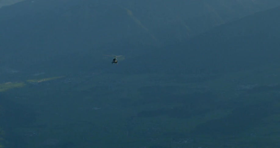 A helicopter flies through the air