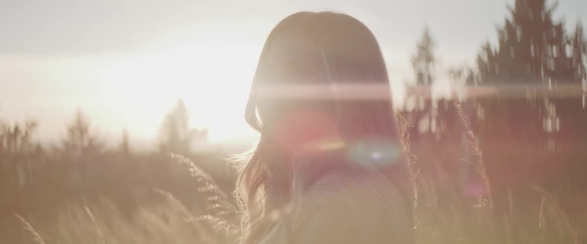 A white woman looks with concern while being outdoors