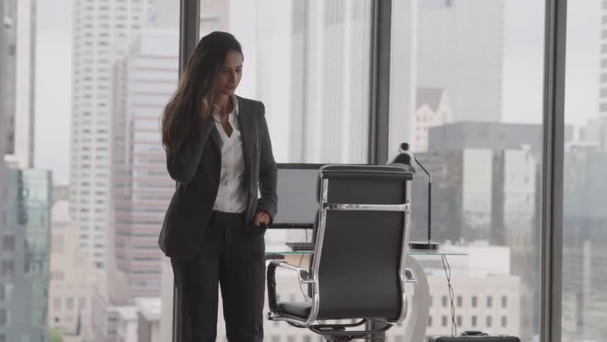 A woman talks on the phone at the office