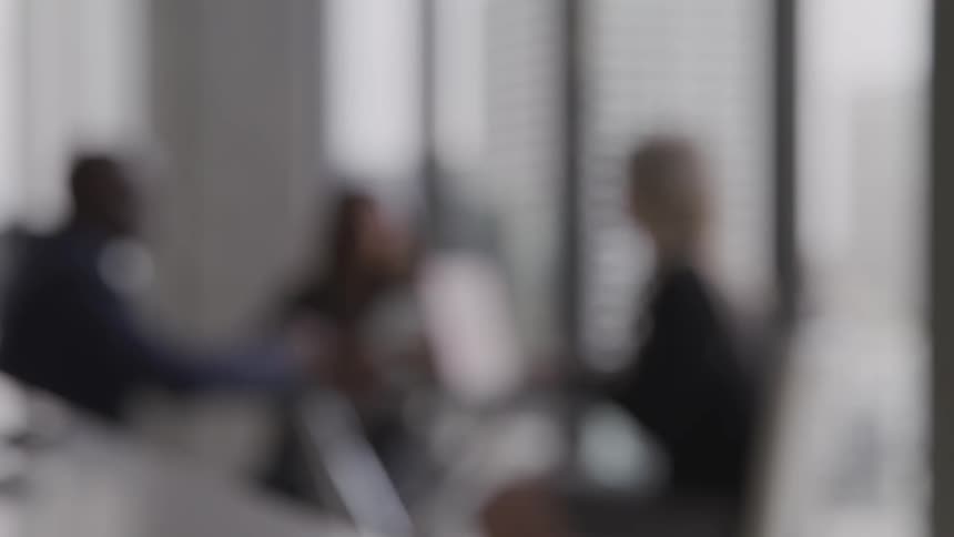 An out of focus shot of three people sitting at a table