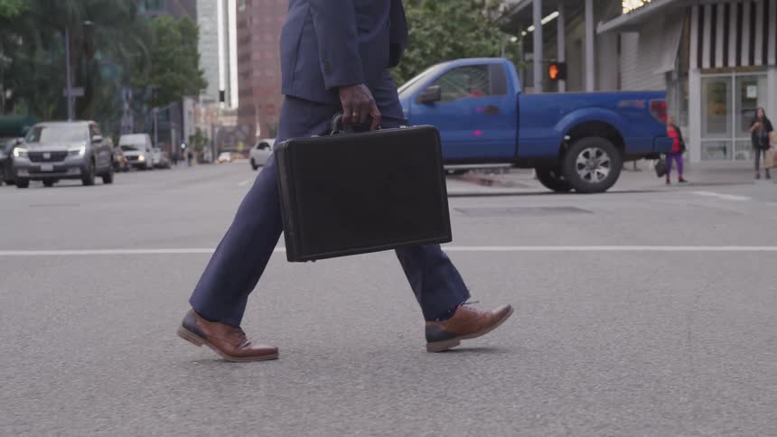 Man with suit and case walk in the city road