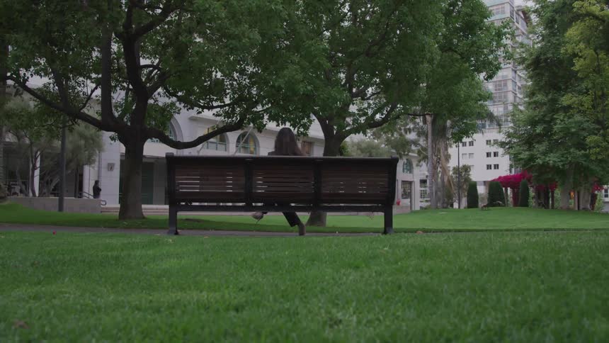 A woman sits on the bench