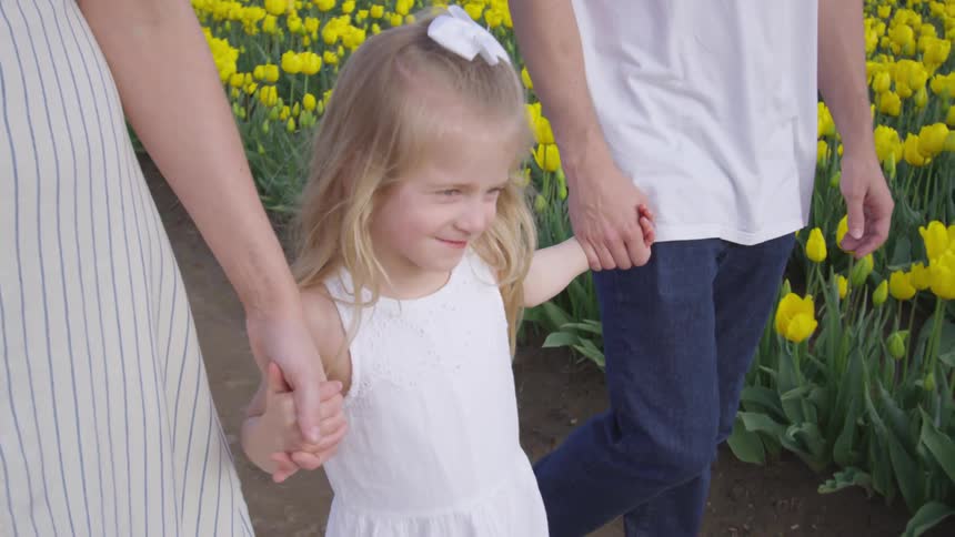 A beauty girl walks with her parent