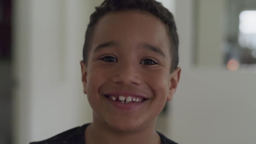 Young boy smiling and posing for a picture