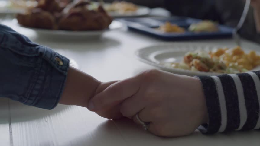 A person holding a childs hand