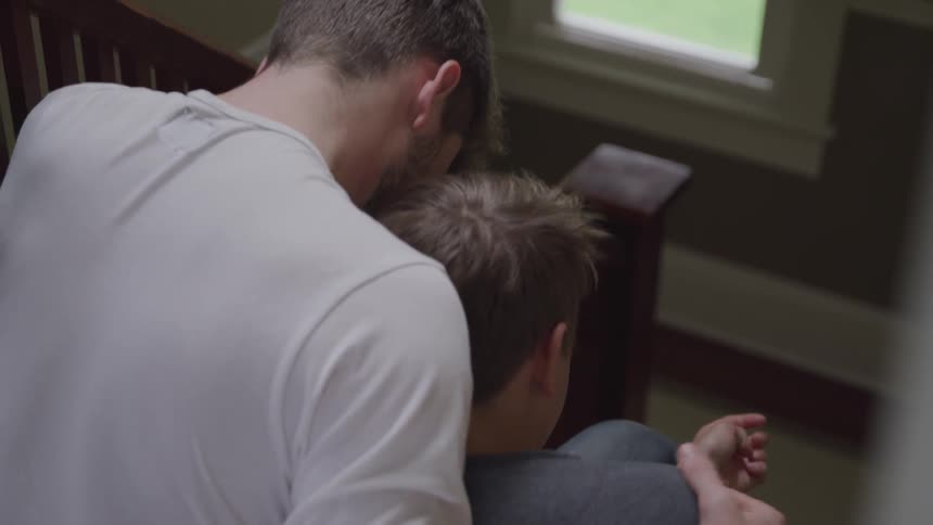 A man caring his sad younger brother