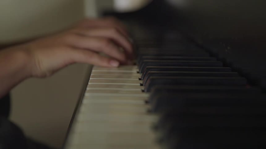 Man plays the piano indoors