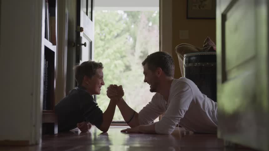 A father and son arm wrestling