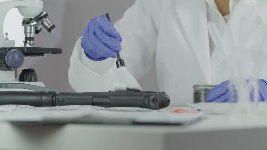 A woman is cleaning off science equipment