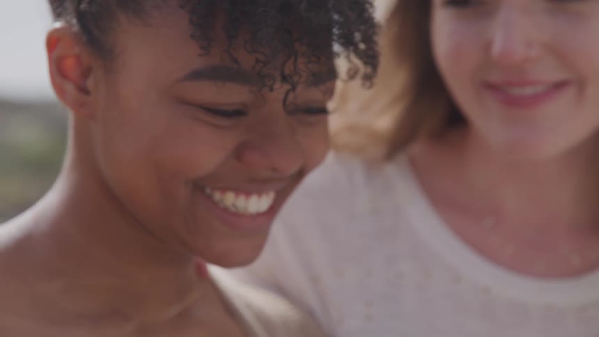 Girlfriends talk and laugh with each other outside