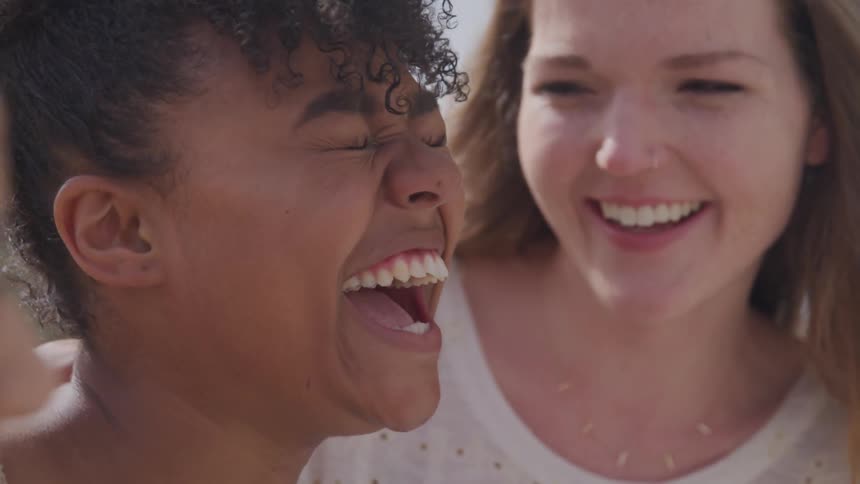 A group of female friends break into laughter