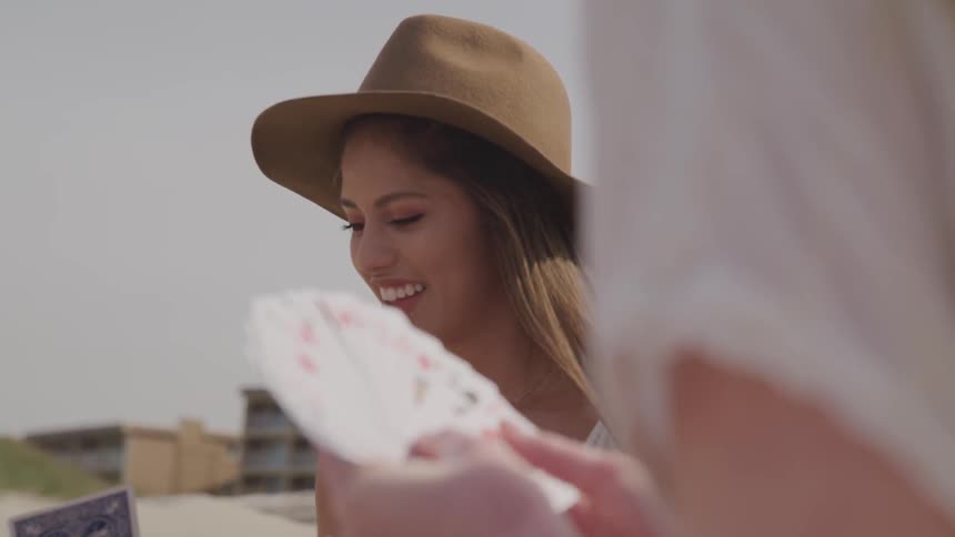Girls sit outside and play cards