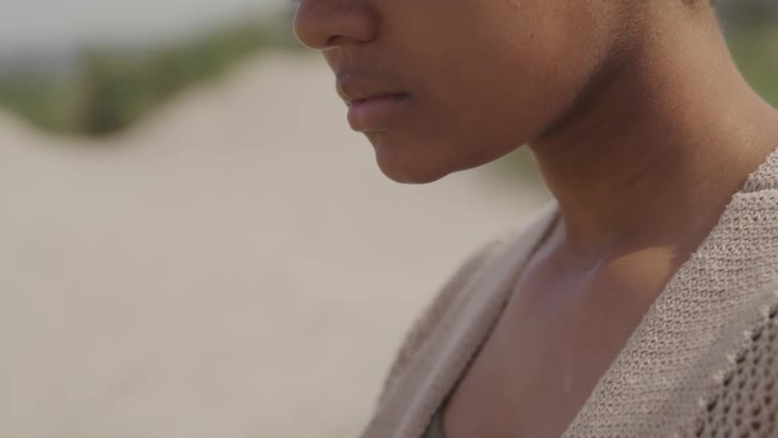 A woman is standing on the beach