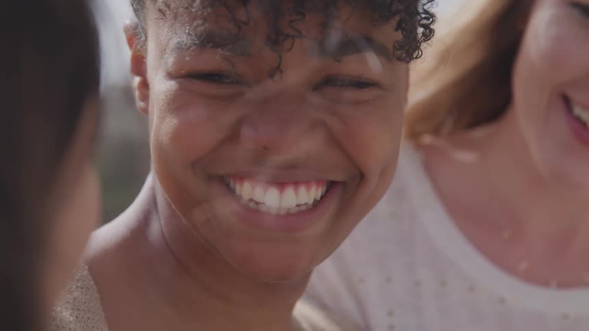 Three women smile and laugh together