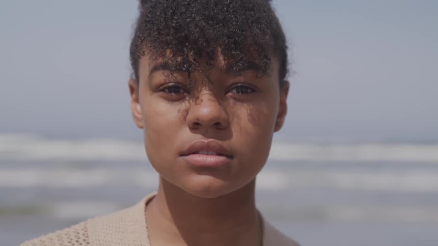 A woman is standing at the beach