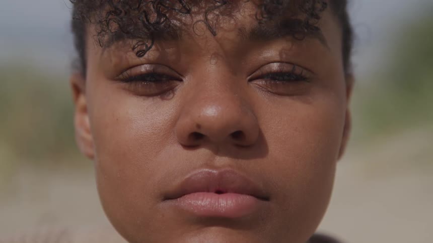 A woman blinks in the sun