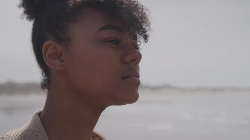 A woman stares into the distance