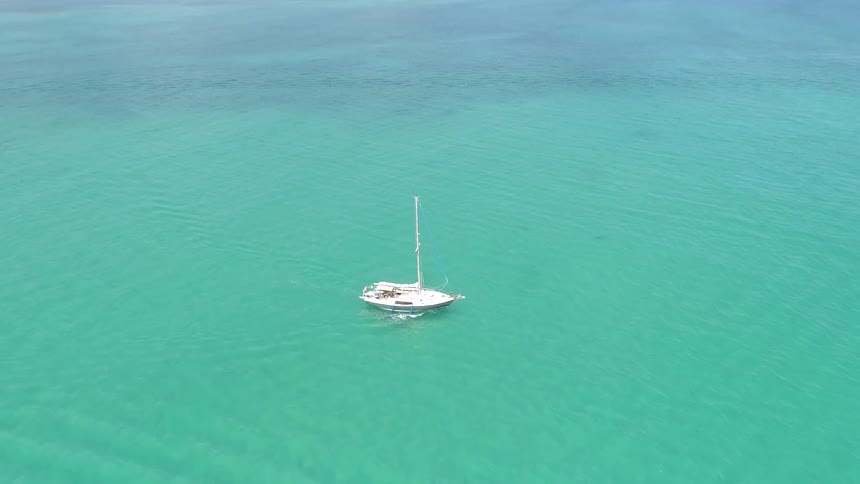 The boat is sailing in the clear waters