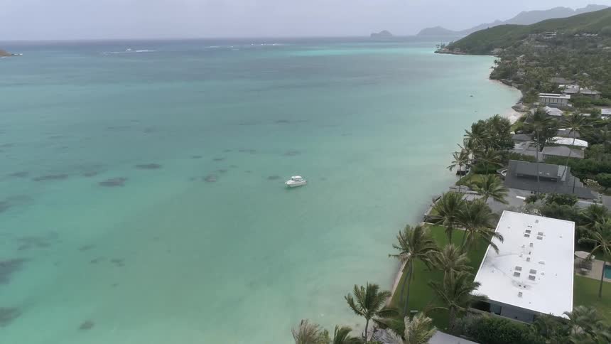 Landscape view of houses on the coast and a boat in the water