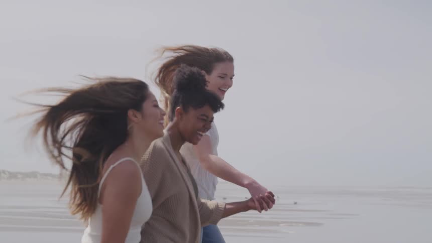 A group of women running in the beach