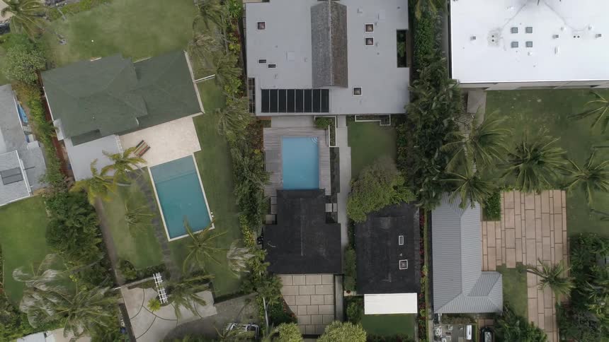 A neighborhood with modern architecture and pools in the backyard
