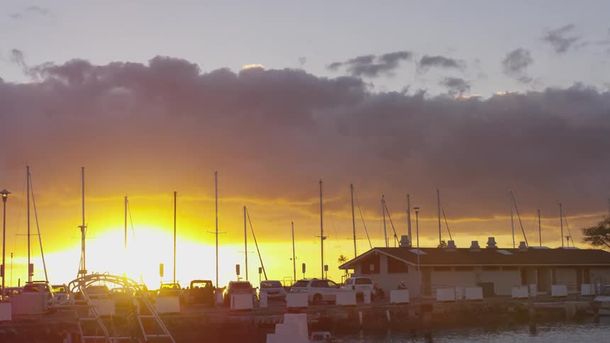 An suv pulling into a marina at sunrise