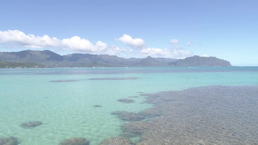A beach with land and the sky in the background