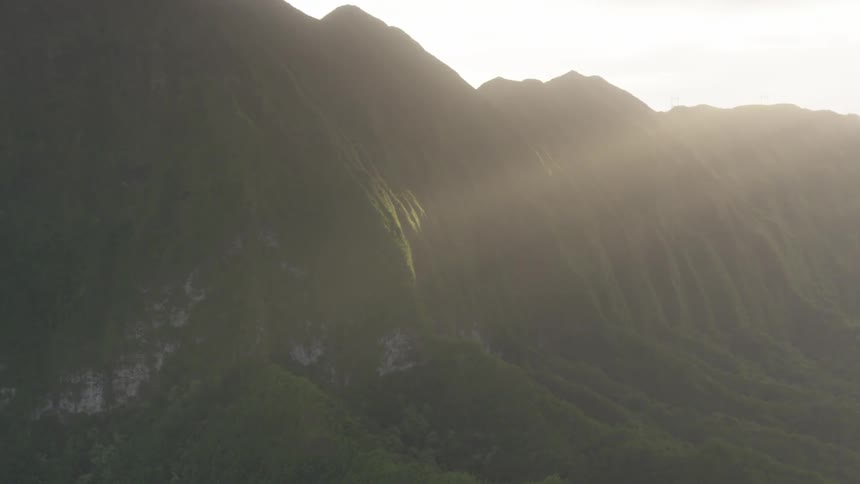 A mountain ridge covered in vegetation during the day