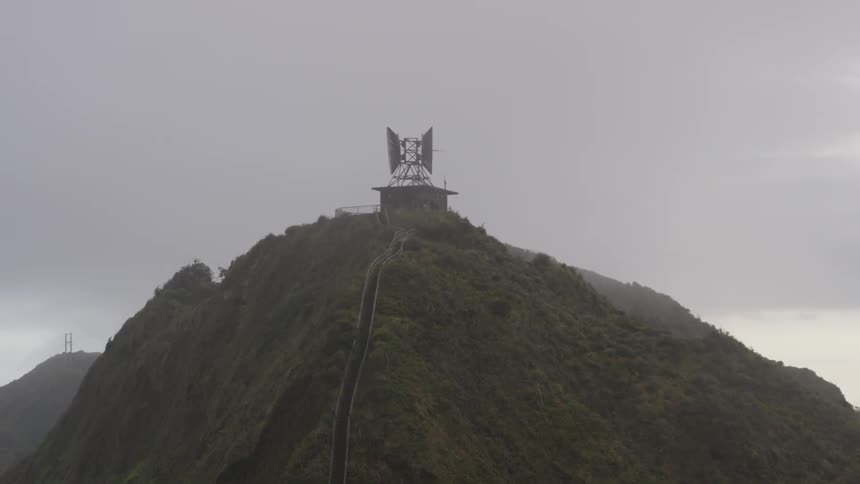 A satellite dish is at the top of the mountain