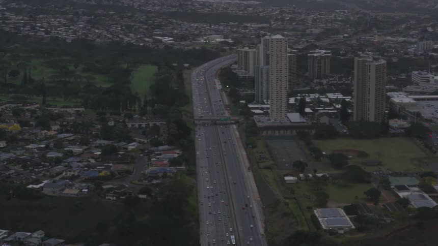 Aerial view of a city and cars driving down the freeway
