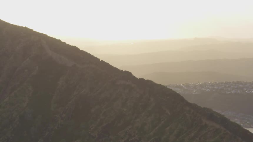 Mountain with waterways and a city beyond it