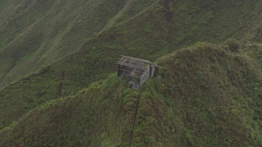 Birds eye view of hills with an abandoned building on top