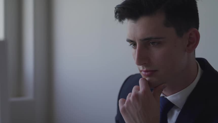 A man is looking at his computer in the office